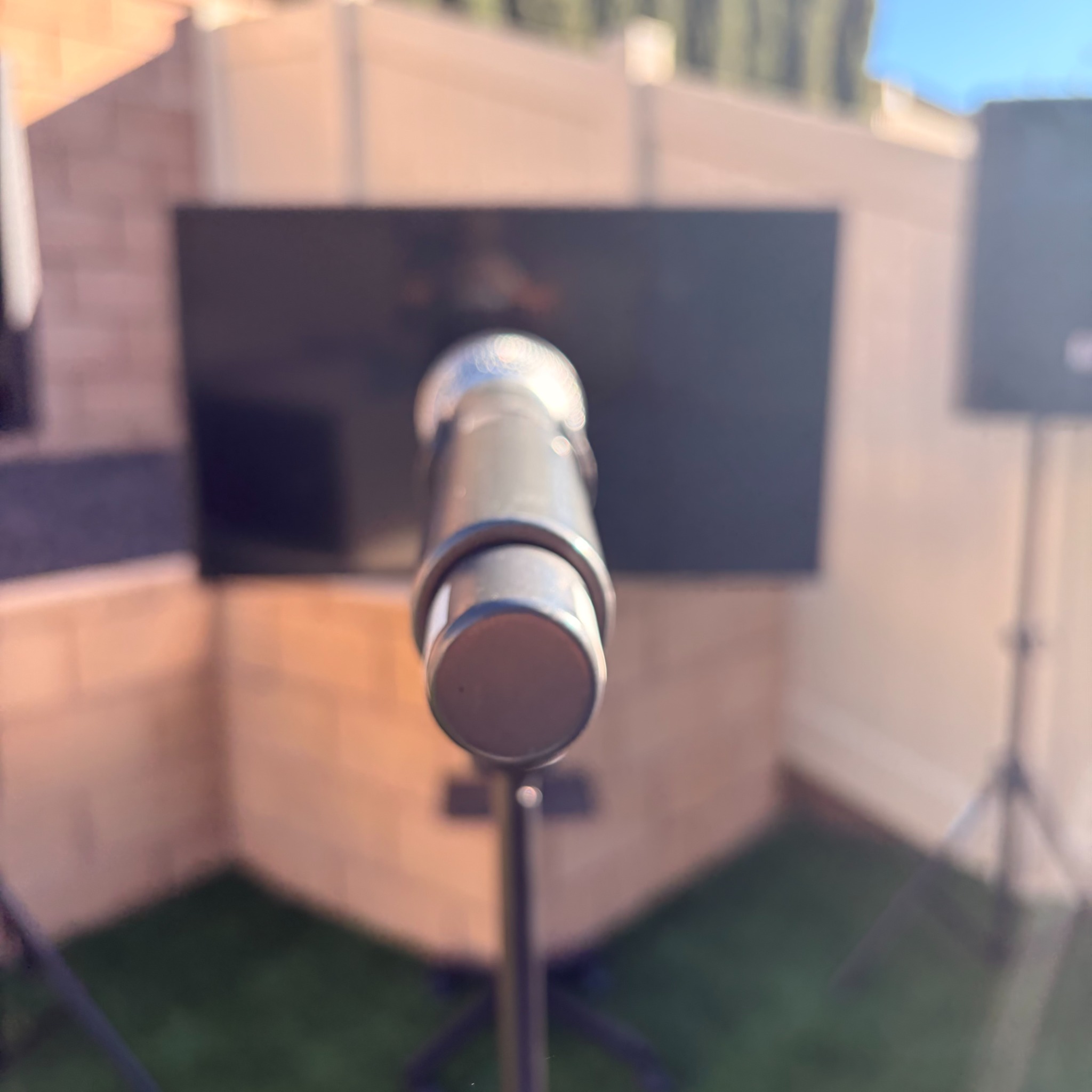 Wireless microphone in front of a Palmwood Rentals karaoke setup